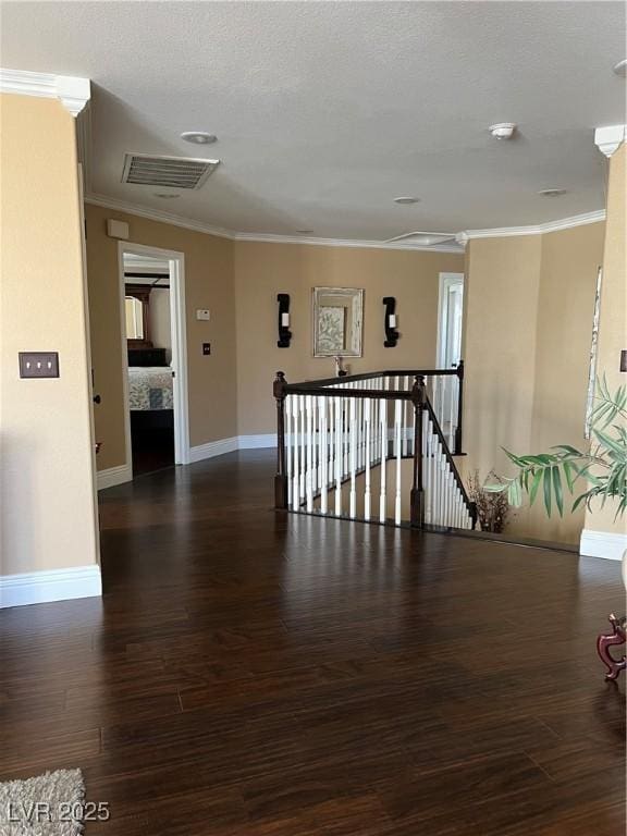 hallway featuring an upstairs landing, ornamental molding, baseboards, and wood finished floors