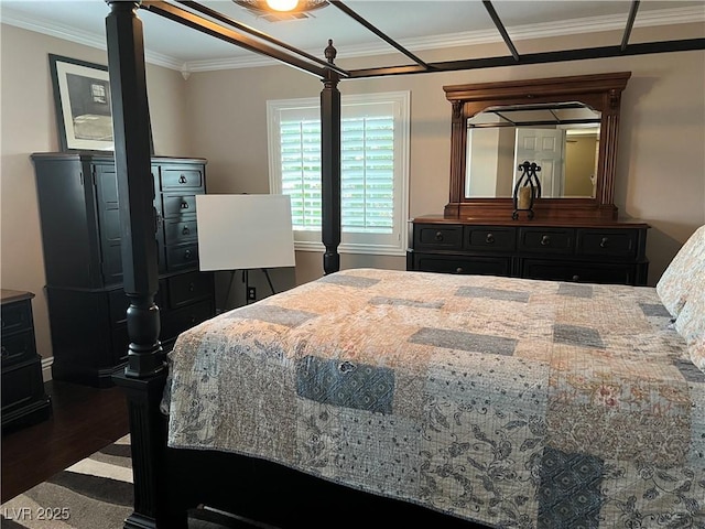 bedroom featuring ornamental molding and wood finished floors