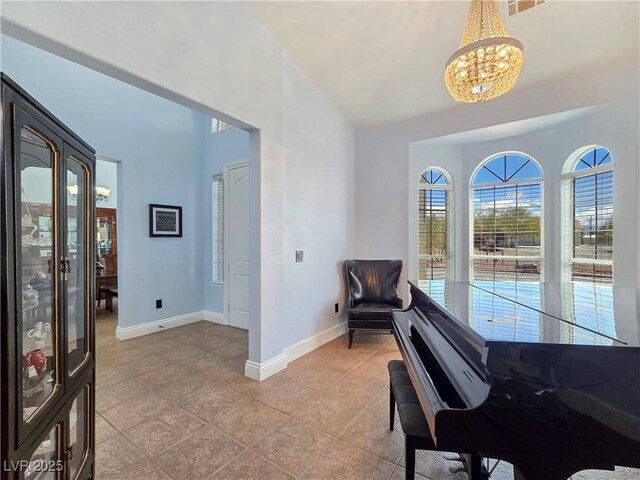 3780 Shawnee Ave, Pahrump, NV 89048 - sitting room with a chandelier, baseboards, light tile patterned floors, and vaulted ceiling