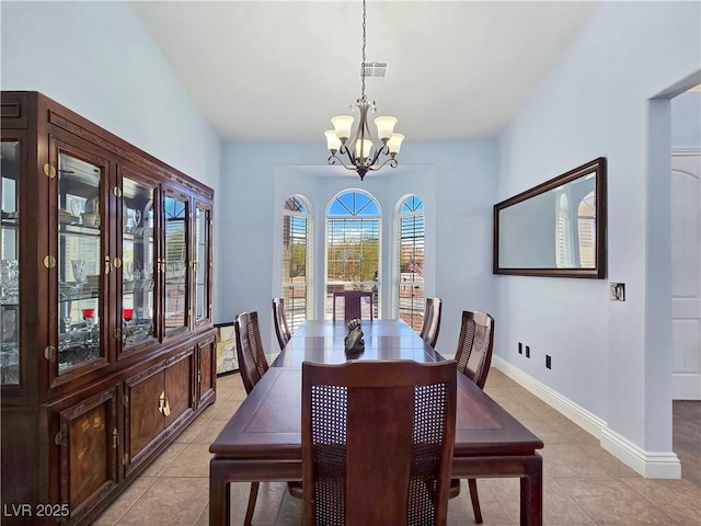 3780 Shawnee Ave, Pahrump, NV 89048 - dining space featuring a chandelier, light tile patterned flooring, and baseboards