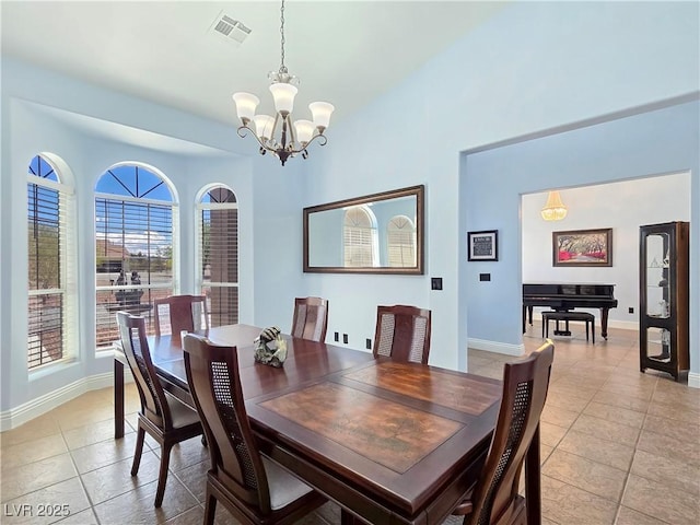 3780 Shawnee Ave, Pahrump, NV 89048 - dining space with light tile patterned floors, a chandelier, and baseboards