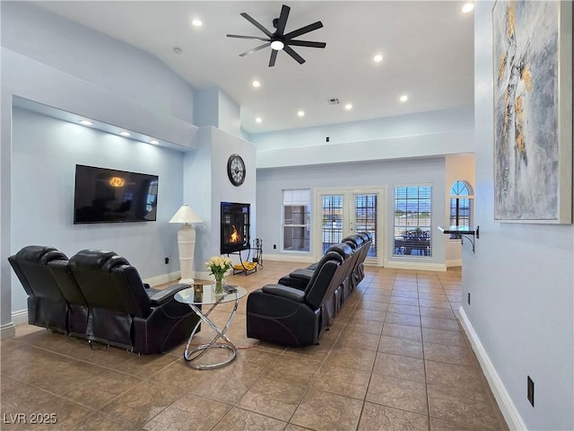 3780 Shawnee Ave, Pahrump, NV 89048 - tiled living room featuring a ceiling fan, recessed lighting, baseboards, and a glass covered fireplace