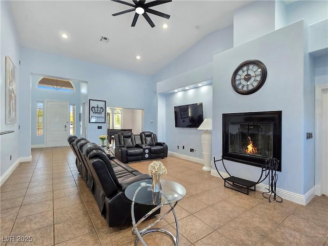 3780 Shawnee Ave, Pahrump, NV 89048 - living area featuring ceiling fan, tile patterned flooring, a glass covered fireplace, high vaulted ceiling, and recessed lighting