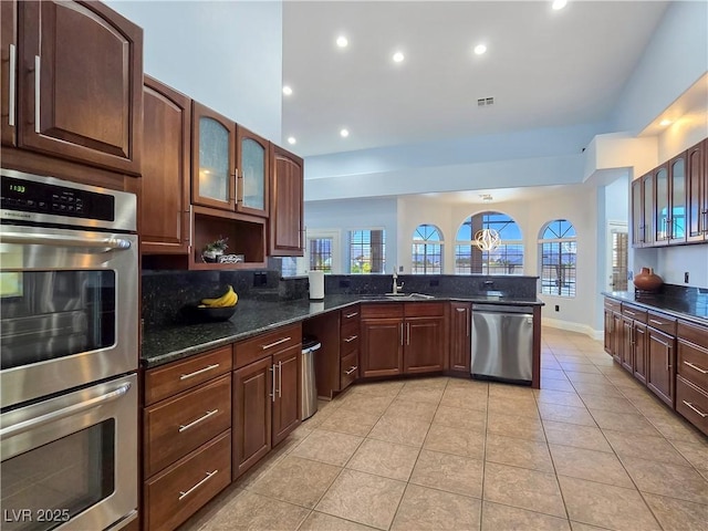 3780 Shawnee Ave, Pahrump, NV 89048 - kitchen with appliances with stainless steel finishes, a sink, recessed lighting, light tile patterned floors, and dark stone counters