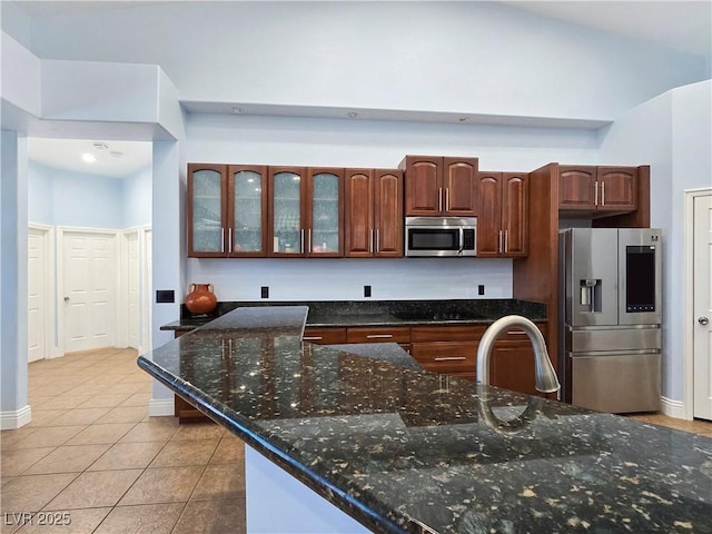3780 Shawnee Ave, Pahrump, NV 89048 - kitchen with appliances with stainless steel finishes, light tile patterned floors, a sink, glass insert cabinets, and baseboards