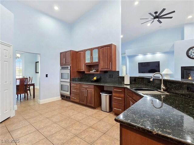 3780 Shawnee Ave, Pahrump, NV 89048 - kitchen featuring a sink, double oven, high vaulted ceiling, backsplash, and light tile patterned floors