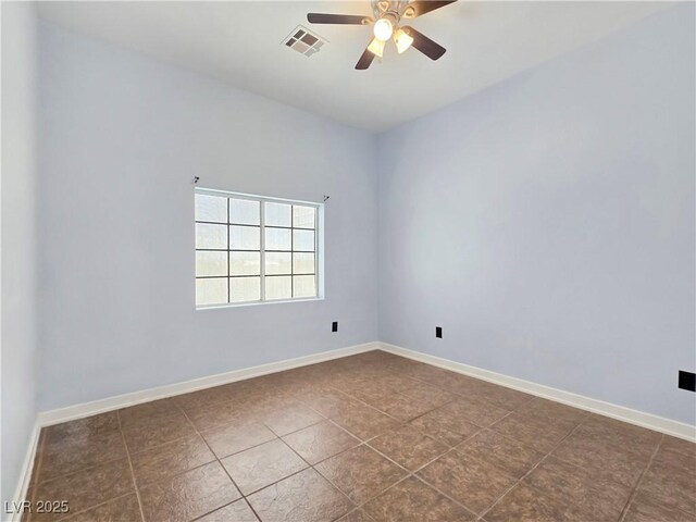 3780 Shawnee Ave, Pahrump, NV 89048 - unfurnished room with a ceiling fan, baseboards, and dark tile patterned floors