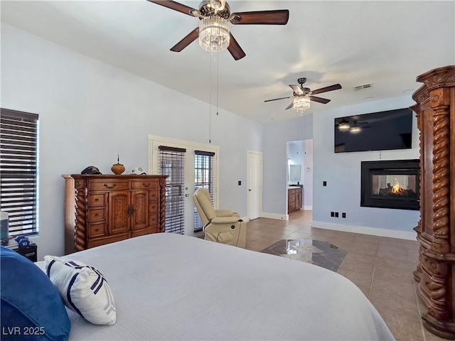 3780 Shawnee Ave, Pahrump, NV 89048 - tiled bedroom with a multi sided fireplace, baseboards, a ceiling fan, and connected bathroom