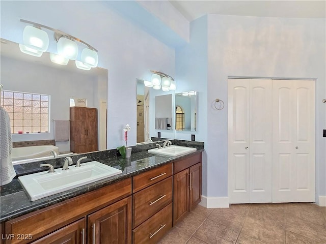 3780 Shawnee Ave, Pahrump, NV 89048 - bathroom featuring tile patterned floors, double vanity, baseboards, and a bath
