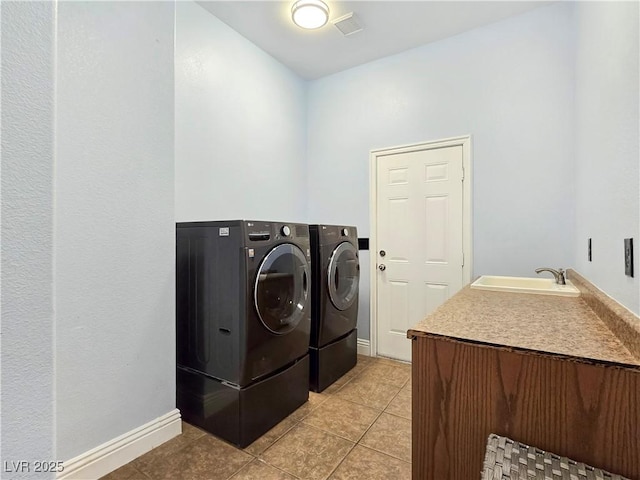 3780 Shawnee Ave, Pahrump, NV 89048 - clothes washing area featuring washing machine and dryer, light tile patterned floors, and baseboards