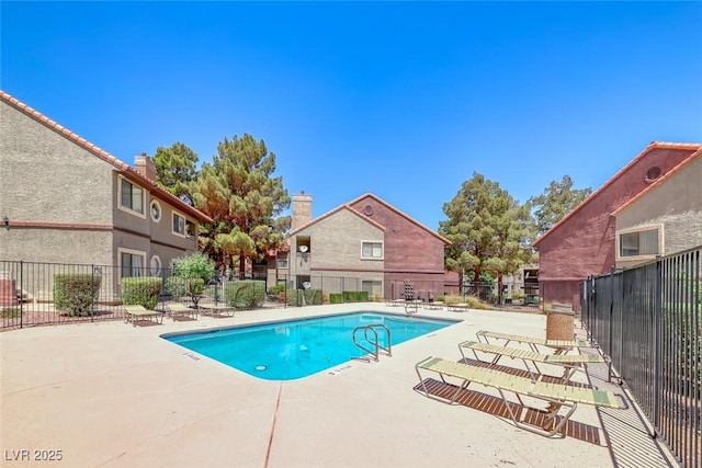 community pool featuring a patio area and fence