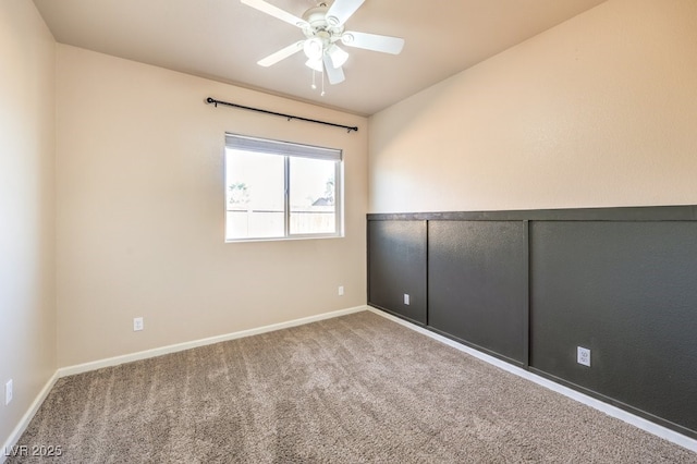 spare room featuring carpet floors, ceiling fan, and baseboards