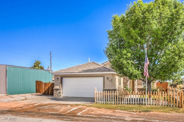 view of front of home featuring an attached garage, stucco siding, concrete driveway, stone siding, and a tile roof
