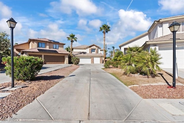 traditional home with driveway, a garage, and stucco siding