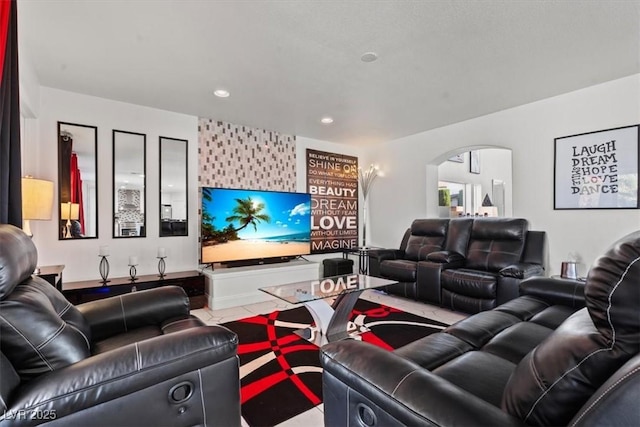living area featuring recessed lighting and arched walkways