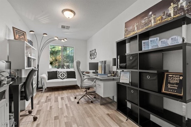 office area featuring wood finished floors and a textured ceiling