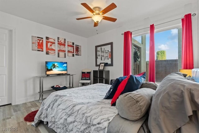 bedroom with wood finished floors, baseboards, and ceiling fan