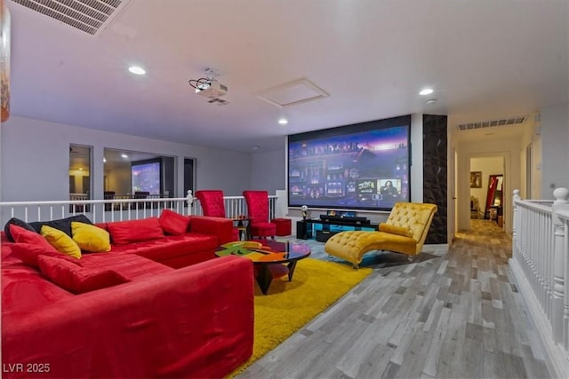 cinema with wood finished floors and recessed lighting
