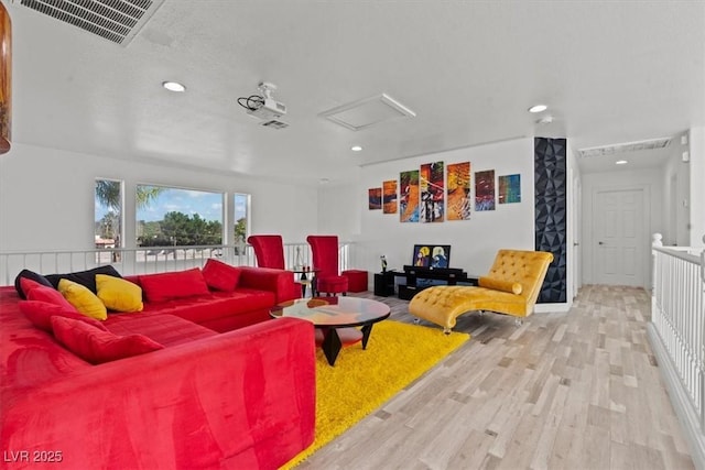 living room with wood finished floors and recessed lighting