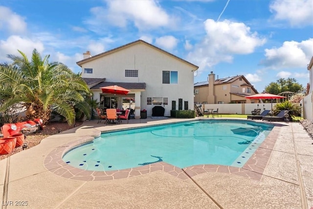 view of swimming pool featuring a patio area and fence