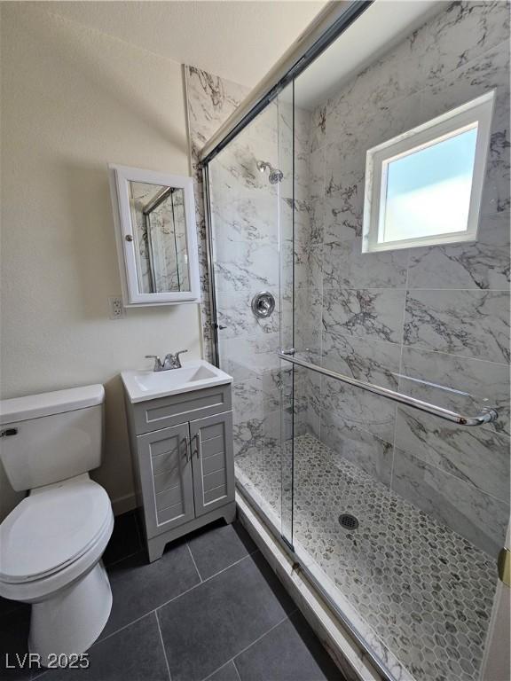 131 Copper St, Henderson, NV 89015 - full bathroom featuring a shower stall, tile patterned flooring, vanity, and toilet