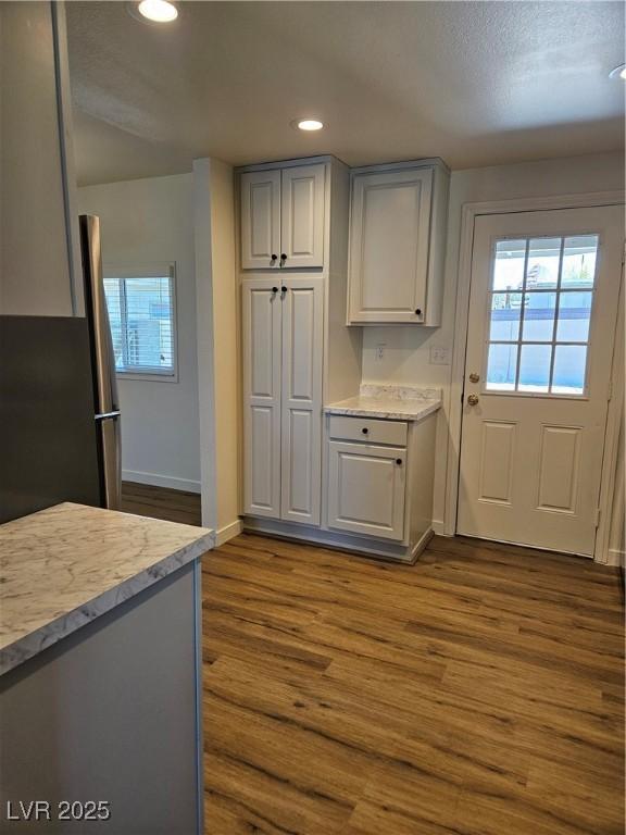 131 Copper St, Henderson, NV 89015 - kitchen with baseboards, plenty of natural light, dark wood-style floors, recessed lighting, and gray cabinets