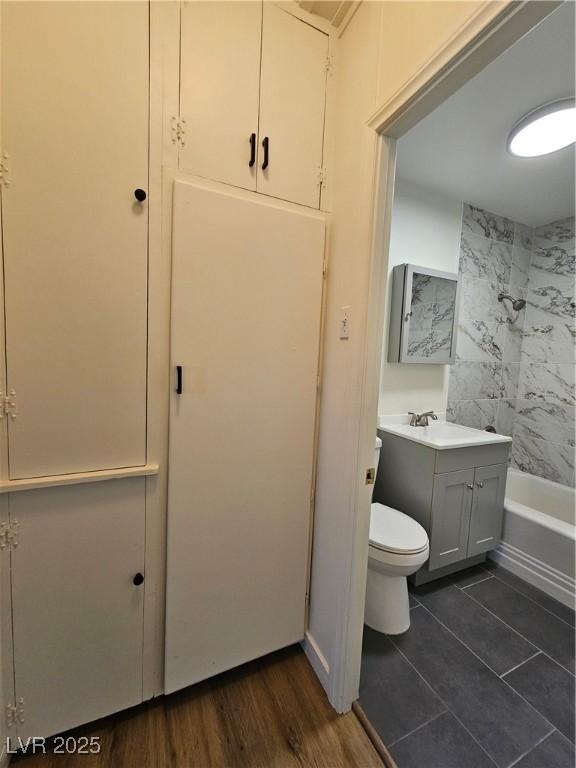 131 Copper St, Henderson, NV 89015 - bathroom with toilet, washtub / shower combination, vanity, and tile patterned flooring
