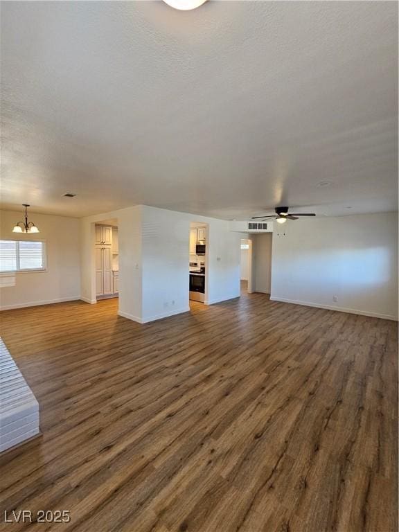 unfurnished living room with a chandelier, baseboards, wood finished floors, and a ceiling fan