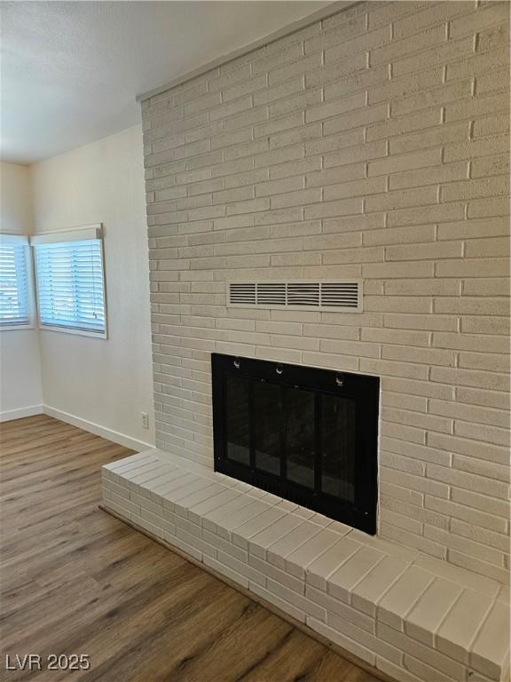 131 Copper St, Henderson, NV 89015 - detailed view of a fireplace, baseboards, and wood finished floors