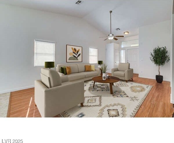 living room featuring wood finished floors, lofted ceiling, ceiling fan, and baseboards