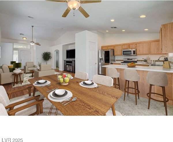 dining area with a ceiling fan, lofted ceiling, recessed lighting, and arched walkways