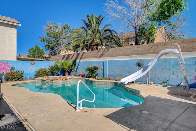 view of swimming pool with a water slide, a fenced backyard, and a patio