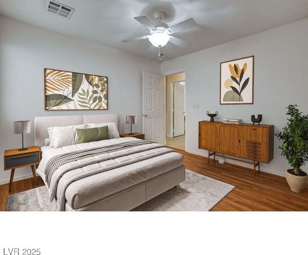 bedroom featuring wood finished floors, baseboards, and a ceiling fan