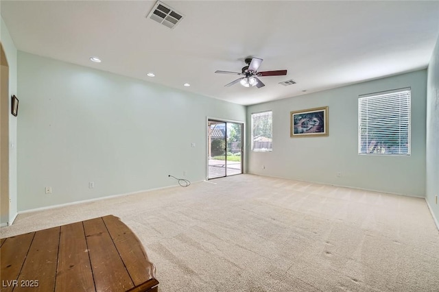 empty room featuring carpet flooring, a ceiling fan, recessed lighting, and baseboards