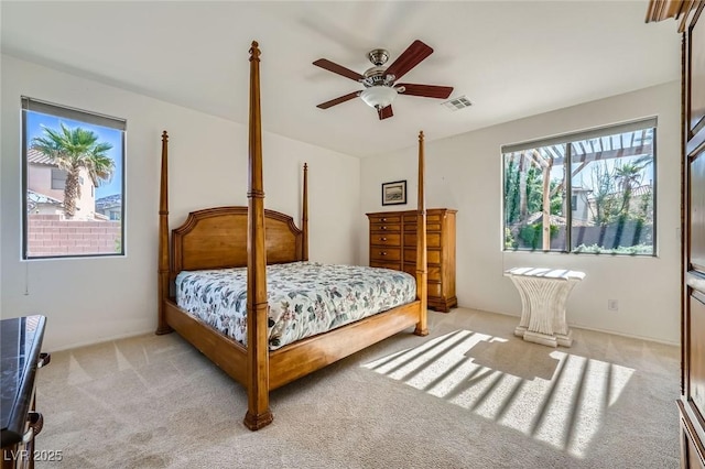 bedroom featuring light carpet and ceiling fan