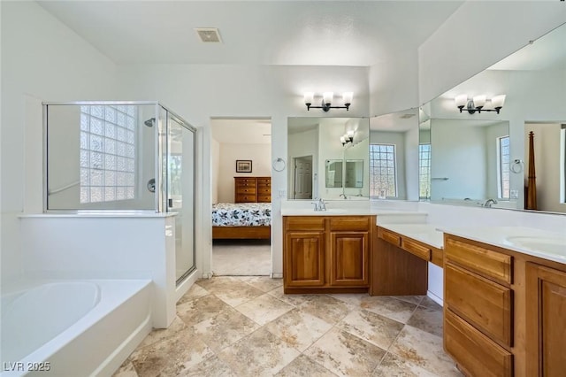 ensuite bathroom featuring a chandelier, a shower stall, and double vanity