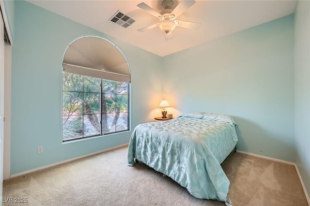 carpeted bedroom with baseboards and ceiling fan