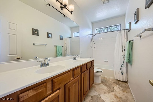 bathroom featuring double vanity, toilet, shower / bathtub combination with curtain, and baseboards