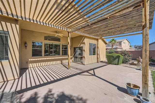 view of patio / terrace featuring ceiling fan and fence