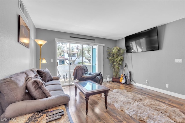 living room with wood finished floors and baseboards