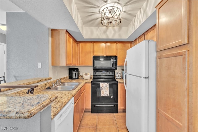 kitchen with black appliances, a sink, a peninsula, light tile patterned floors, and a textured wall
