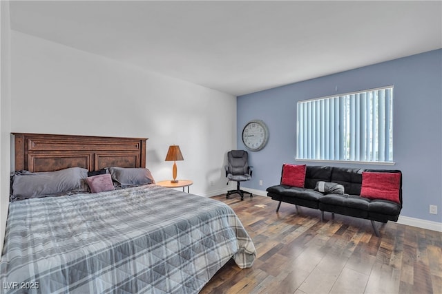 bedroom with baseboards and wood finished floors