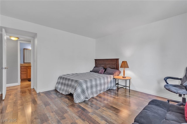 bedroom with wood finished floors and baseboards