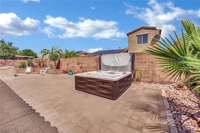 view of patio / terrace featuring a fenced backyard and a hot tub