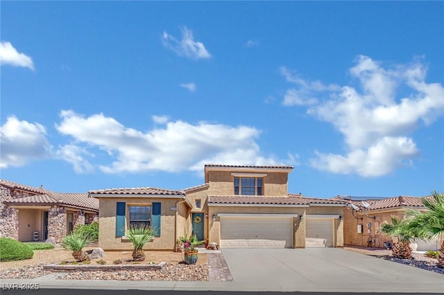 view of front of property featuring stucco siding, a tile roof, an attached garage, and concrete driveway