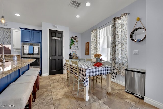 dining space with baseboards and recessed lighting