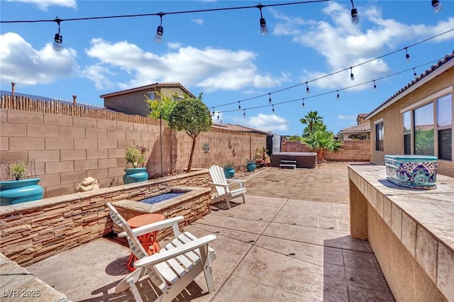 view of patio with a fire pit and a fenced backyard