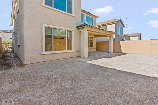 10851 Hanwicke Harbor Ave, Las Vegas, NV 89166 - rear view of property featuring stucco siding, a patio area, and a tiled roof