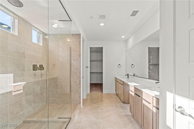 10851 Hanwicke Harbor Ave, Las Vegas, NV 89166 - bathroom with a shower stall, double vanity, a spacious closet, recessed lighting, and tile patterned flooring