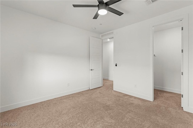 10851 Hanwicke Harbor Ave, Las Vegas, NV 89166 - unfurnished bedroom with light carpet, baseboards, a ceiling fan, and a walk in closet